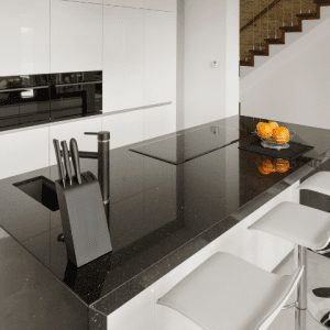 Modern kitchen with black granite worktop island and white cabinets – The Granite House, Bicester