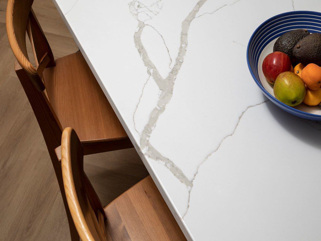 Quartz worktop with with white background and grey veining.